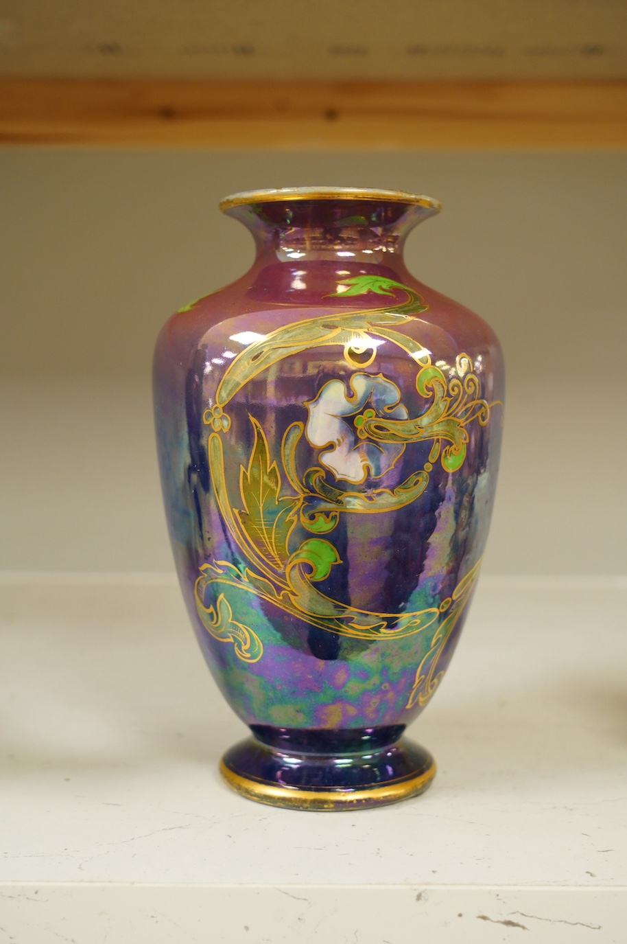 A Shelley Walter Slater pink and blue lustre peacock design vase, signed, 22cm high. Condition - fair to good, some wear to the gilt on the rim